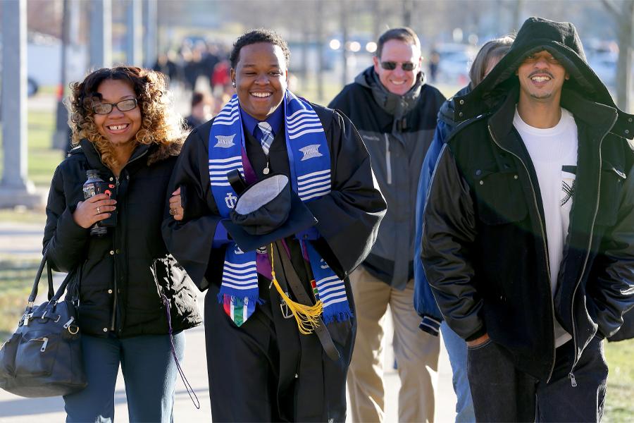 Amos Malone walks to commencement with his family.