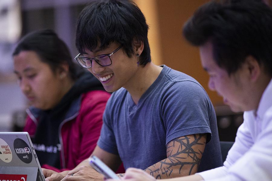 A student works on a laptop.