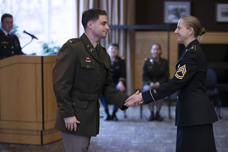 Two service people shake hands.